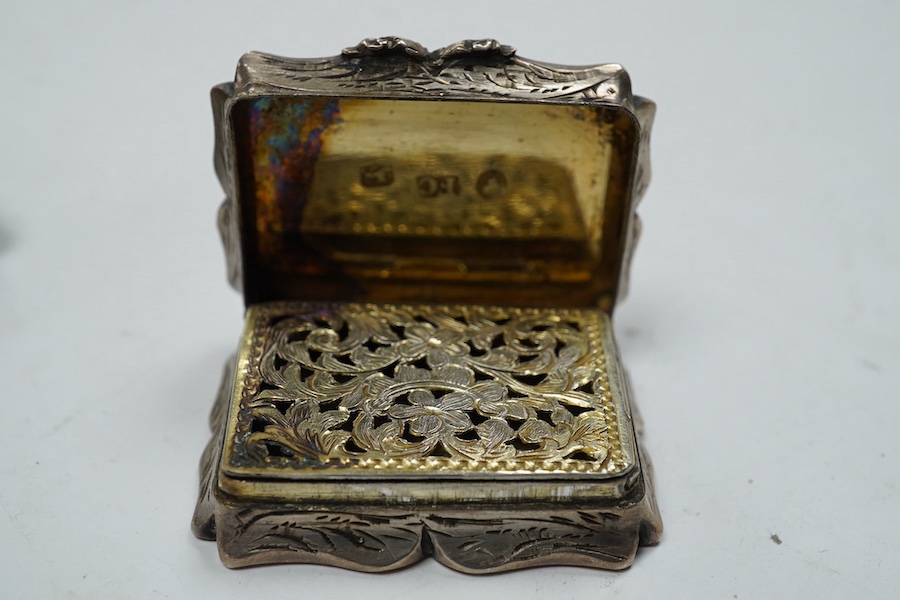 A late George III silver rectangular vinaigrette, John Thropp, Birmingham, 1819, 39mm and one other foliate scroll engraved silver vinaigrette, Birmingham, 1845. Condition - poor to fair